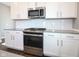 Modern kitchen featuring white cabinets, stainless steel appliances, sleek countertops, and a subway tile backsplash at 9812 Ridgecrest Ln, McCordsville, IN 46055