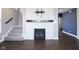 Living room with a modern fireplace featuring a white stone surround and a dark wood mantel at 9812 Ridgecrest Ln, McCordsville, IN 46055