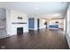 Open-concept living room with fireplace, adjacent kitchen, and staircase, offering a bright and inviting space at 9812 Ridgecrest Ln, McCordsville, IN 46055