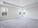 A large main bedroom with large windows and a tray ceiling for plenty of natural light at 9812 Ridgecrest Ln, McCordsville, IN 46055