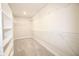 Walk-in closet with carpet flooring and multiple levels of wire shelving for storage at 9812 Ridgecrest Ln, McCordsville, IN 46055