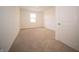 Neutral bedroom with carpet, a window, and a white door at 101 Ames Dr, Whiteland, IN 46184