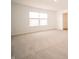 A large, carpeted bedroom has a window, and an entrance to another room at 101 Ames Dr, Whiteland, IN 46184
