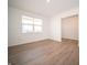 View of a sunlit living room, featuring wood flooring and an open design at 101 Ames Dr, Whiteland, IN 46184