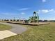 Community playground with swings and play structure, accessible path at 101 Ames Dr, Whiteland, IN 46184
