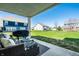 Relaxing covered patio with a grill and outdoor furniture overlooking the backyard at 11034 Saddlebred Dr, Indianapolis, IN 46239