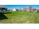 Lush backyard featuring multiple homes, perfect for outdoor enjoyment and neighborhood views at 11034 Saddlebred Dr, Indianapolis, IN 46239