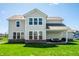 Exterior view of the home, showcasing the spacious backyard and covered patio area at 11034 Saddlebred Dr, Indianapolis, IN 46239