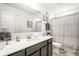 Bathroom featuring stylish vanity, well-lit mirror, and classic shower with curtain at 11034 Saddlebred Dr, Indianapolis, IN 46239