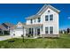 Inviting two-story home with a landscaped lawn, an attached two car garage and covered front porch at 11034 Saddlebred Dr, Indianapolis, IN 46239