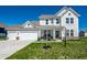 Charming two-story home featuring a two-car garage, welcoming front porch, and well-maintained lawn at 11034 Saddlebred Dr, Indianapolis, IN 46239