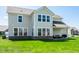 Exterior backyard showing lawn, patio, and home with ample natural light shining through the windows at 11034 Saddlebred Dr, Indianapolis, IN 46239