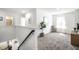 Bright hallway featuring neutral paint, plush carpet, and a sunlit room at 11034 Saddlebred Dr, Indianapolis, IN 46239
