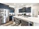 Modern kitchen with a spacious island, stainless steel appliances, and navy blue cabinetry at 11034 Saddlebred Dr, Indianapolis, IN 46239