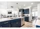 Open kitchen featuring an island with bar seating, stainless steel appliances, and seamless access to the living area at 11034 Saddlebred Dr, Indianapolis, IN 46239
