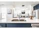 Bright kitchen with a large island and view into an open-concept living space at 11034 Saddlebred Dr, Indianapolis, IN 46239