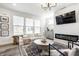 Bright living room with a fireplace, large windows, and chic decor creating a comfortable atmosphere at 11034 Saddlebred Dr, Indianapolis, IN 46239