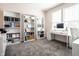 Bright and spacious home office featuring a large desk, shelves, and natural light at 11034 Saddlebred Dr, Indianapolis, IN 46239