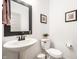 Clean powder room with a pedestal sink, a round toilet, and minimalistic decor at 11034 Saddlebred Dr, Indianapolis, IN 46239