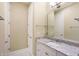 Bathroom featuring granite countertops, a large mirror, and white cabinets at 11710 Cold Creek Ct, Zionsville, IN 46077