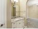 Bathroom featuring granite countertops, a large mirror, and white cabinets at 11710 Cold Creek Ct, Zionsville, IN 46077