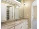 Bright bathroom features granite countertop vanity, decorative lighting, and archway to adjoining room at 11710 Cold Creek Ct, Zionsville, IN 46077