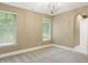 Spacious bedroom with neutral walls, carpeted floors, and a decorative chandelier at 11710 Cold Creek Ct, Zionsville, IN 46077
