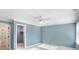 Cozy bedroom with a ceiling fan, a walk-in closet, and an ensuite bathroom entrance at 11710 Cold Creek Ct, Zionsville, IN 46077