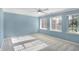 Bright bedroom with a ceiling fan, neutral carpet, and three large windows at 11710 Cold Creek Ct, Zionsville, IN 46077