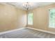 Bright bedroom with neutral walls and plush carpeting, illuminated by a decorative chandelier at 11710 Cold Creek Ct, Zionsville, IN 46077