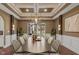 Elegant dining room with a decorative ceiling, modern light fixture, large table, and outdoor view at 11710 Cold Creek Ct, Zionsville, IN 46077