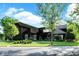 Beautifully landscaped exterior showcasing lush lawn and mature trees surrounding the dark-painted home at 11710 Cold Creek Ct, Zionsville, IN 46077
