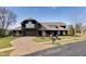 Stunning black two-story home with a well-manicured front yard and circular driveway at 11710 Cold Creek Ct, Zionsville, IN 46077