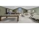 Spacious game room with a dart board, foosball table, pool table, and a comfortable seating area at 11710 Cold Creek Ct, Zionsville, IN 46077
