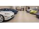 Spacious garage featuring parking for multiple luxury cars, with a wet bar in the back at 11710 Cold Creek Ct, Zionsville, IN 46077