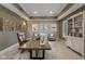 Bright home office with tray ceilings, natural light, desk, chair, cabinet, and wall art at 11710 Cold Creek Ct, Zionsville, IN 46077