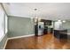 Open kitchen and dining area with hardwood floors, stainless steel appliances, and a kitchen island at 11710 Cold Creek Ct, Zionsville, IN 46077