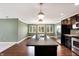 Spacious kitchen with stainless steel appliances, dark cabinetry, a large island, and a view of the dining area at 11710 Cold Creek Ct, Zionsville, IN 46077