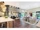 Open-concept living area featuring hardwood floors, a gourmet kitchen, dining area, and a fireplace at 11710 Cold Creek Ct, Zionsville, IN 46077