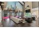 Spacious living room showcasing a city mural, gym, wet bar, dining, open concept, and luxury finishes at 11710 Cold Creek Ct, Zionsville, IN 46077