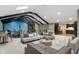 Open concept living room with city skyline views and access to bar, kitchen, and dining at 11710 Cold Creek Ct, Zionsville, IN 46077