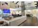 Living room featuring open floor plan, wet bar, view of kitchen and dining, and modern furnishings at 11710 Cold Creek Ct, Zionsville, IN 46077
