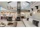 Great room with vaulted ceilings, glass elevator, and a view into the kitchen and dining area at 11710 Cold Creek Ct, Zionsville, IN 46077