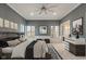 Main bedroom with tray ceilings, large windows, and en-suite bathroom at 11710 Cold Creek Ct, Zionsville, IN 46077