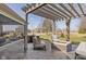 Relaxing backyard patio with a fire pit, stylish furniture, pergola, and expansive lawn at 11710 Cold Creek Ct, Zionsville, IN 46077