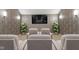 Cozy theater room with comfortable seating, sconce lighting, accent wall and a large flat screen tv at 11710 Cold Creek Ct, Zionsville, IN 46077