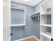 Organized walk-in closet with shelving and hanging rods for maximum storage at 11710 Cold Creek Ct, Zionsville, IN 46077