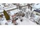 Winter aerial view showcasing a home with a stone chimney, pergola, wooden siding, and a snow-covered yard at 1307 W 161St St, Westfield, IN 46074