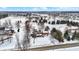 Expansive aerial view of a snow-covered property featuring a charming home with a covered porch and pergola at 1307 W 161St St, Westfield, IN 46074