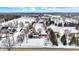Scenic aerial view of a beautiful community with mature trees, nestled amidst snow-covered streets and rooftops at 1307 W 161St St, Westfield, IN 46074